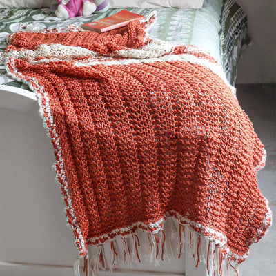 An Orange knitted summer blanket for babies from eri silk -  Download this beautiful silk knitting pattern online from Muezart India 