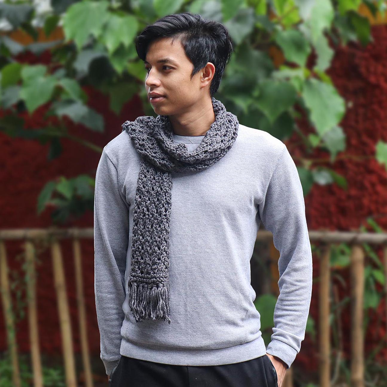A man wearing a grey knitted silk scarf from eri silk -  Download this beautiful silk knitting pattern online from Muezart India 