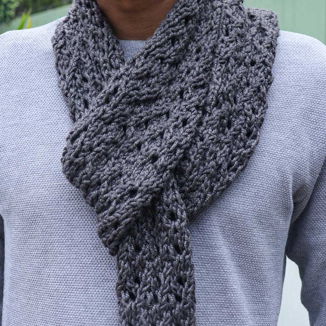 A man wearing a grey knitted silk scarf from eri silk -  Download this beautiful silk knitting pattern online from Muezart India 