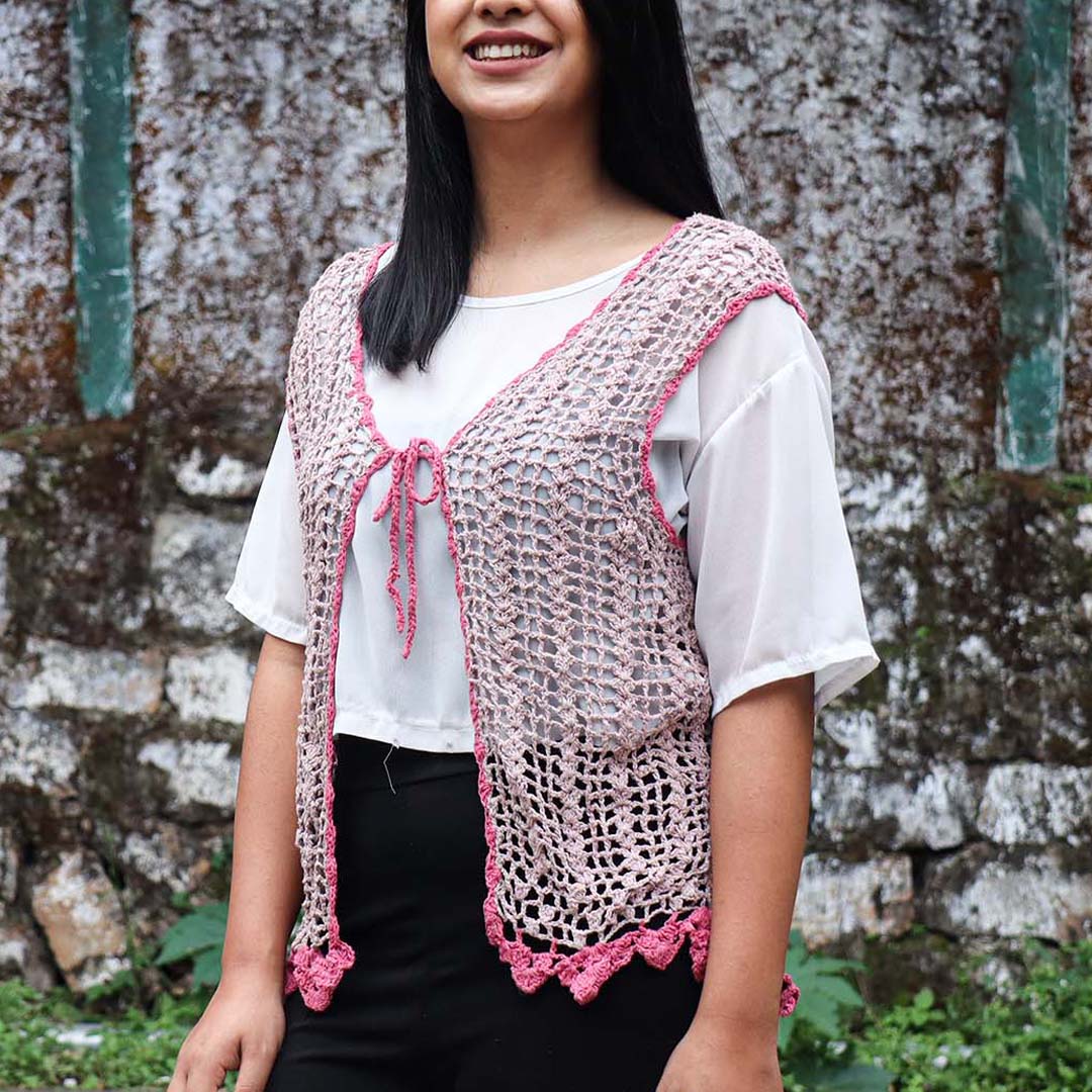 A Women wearing a pink crochet silk scarf from eri silk -  Download this beautiful silk crochet pattern online from Muezart