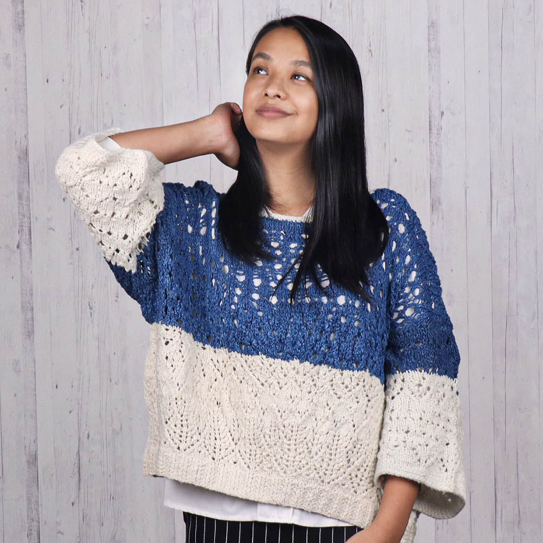 Woman wearing a silk blue knitted open sweater