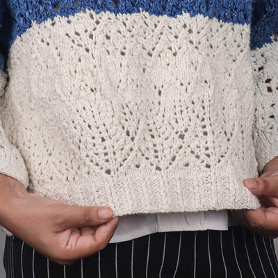 Woman wearing a silk blue knitted open sweater