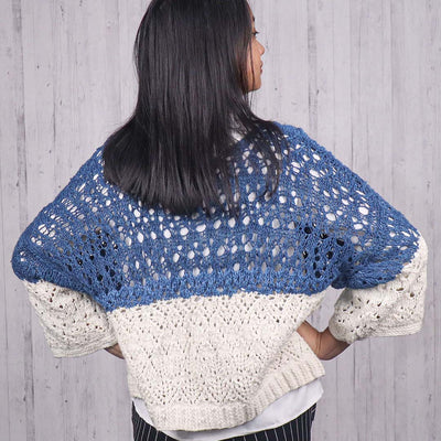 Woman wearing a silk blue knitted open sweater