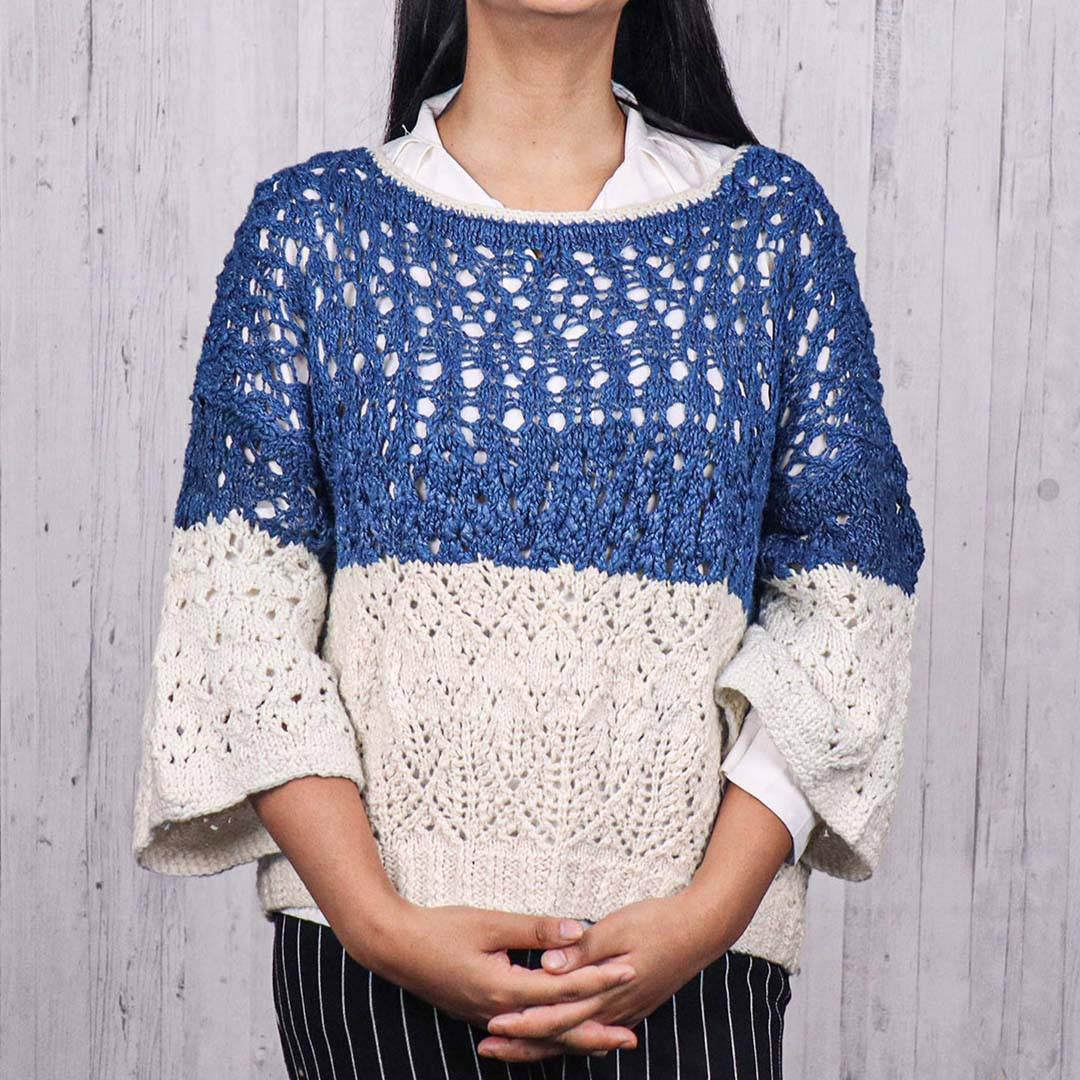 Woman wearing a silk blue knitted open sweater