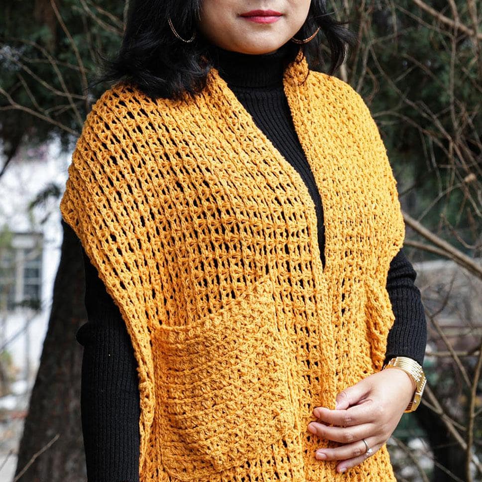 A Women wearing a yellow crochet silk scarf from eri silk -  Download this beautiful silk crochet pattern online from Muezart